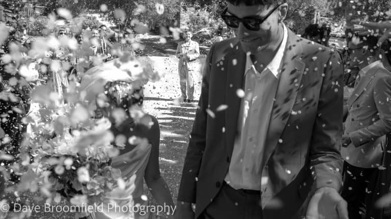 Dorset Wedding Photographer - Image of Bride and Groom with confetti