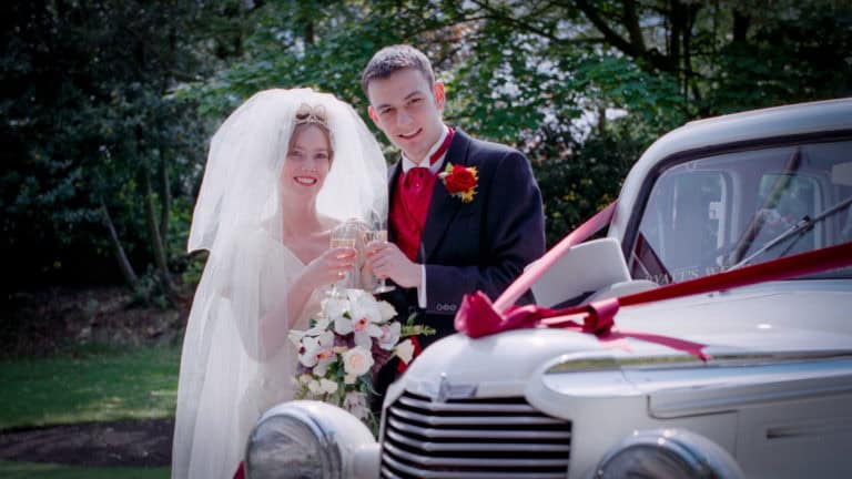 Dorset Wedding Photographer – Image of Bride and Groom by wedding car