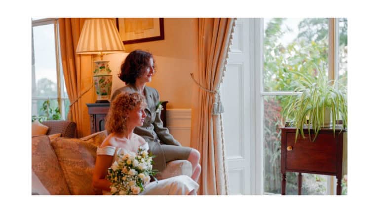 Dorset Wedding Photographer – Image of Bride and Bridesmaid by window