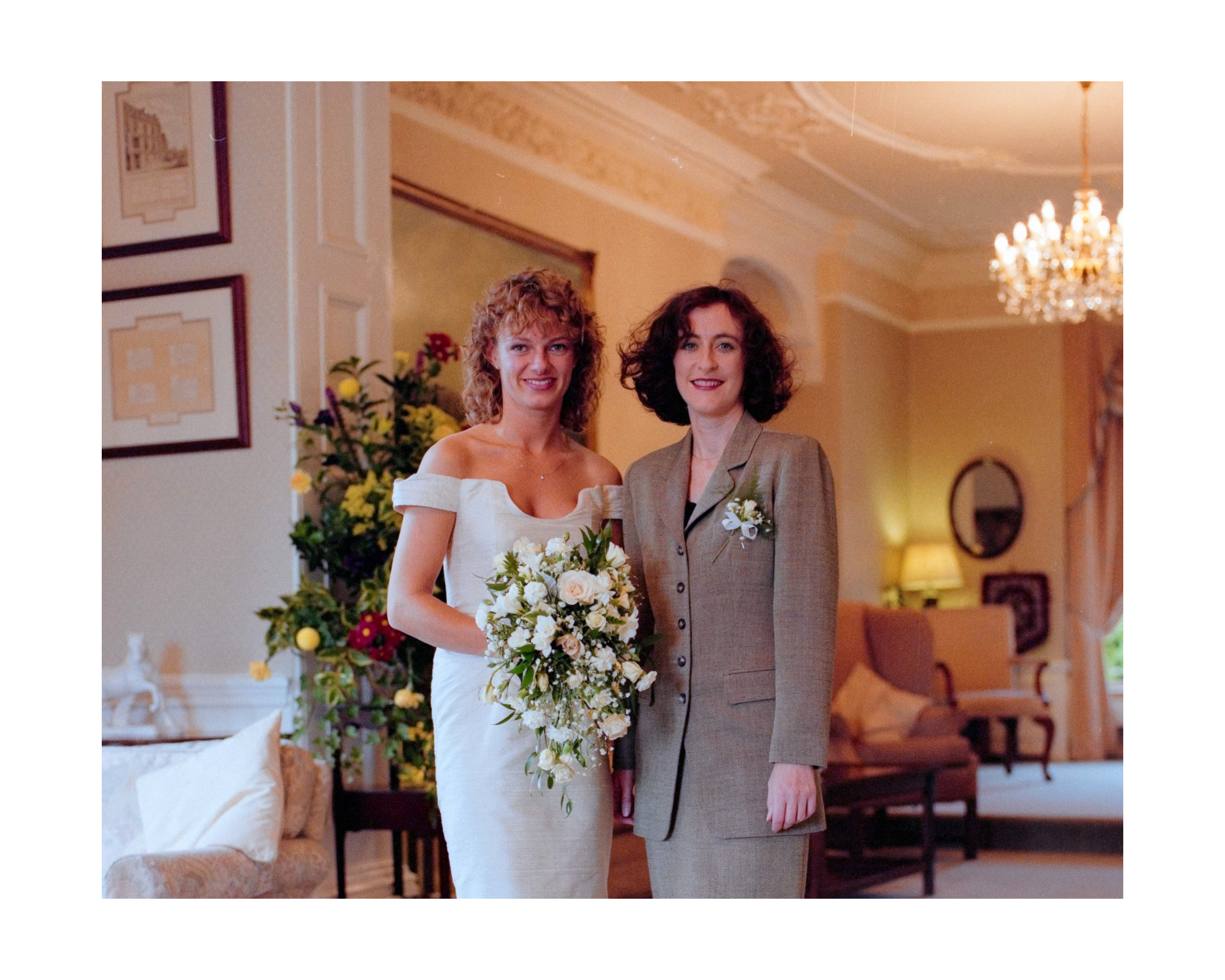Dorset Wedding Photographer – Image of Bride and Bridesmaid by window