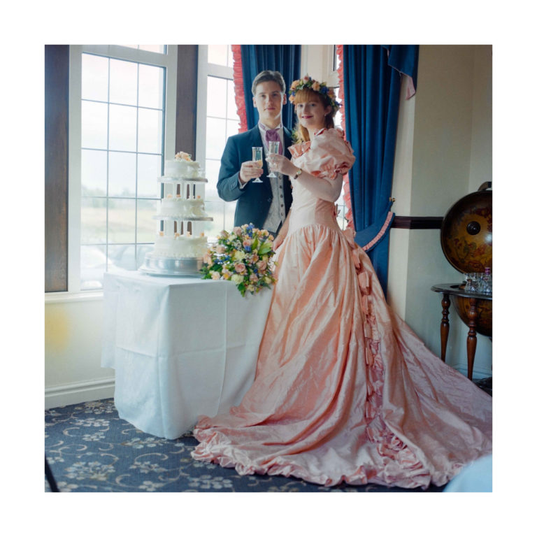 Dorset Wedding Photographer – Image of Bride and Groom by cake